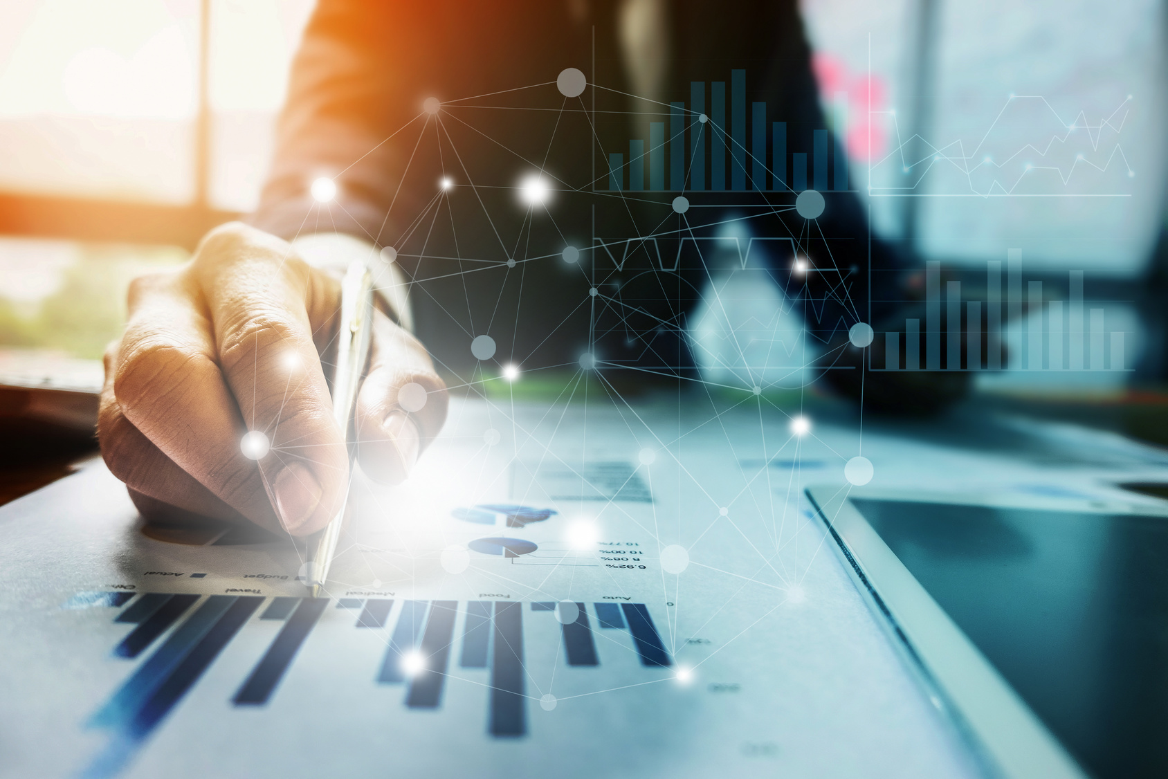 close up businessman hand holding pen and pointing at financial paperwork with social network diagram.
