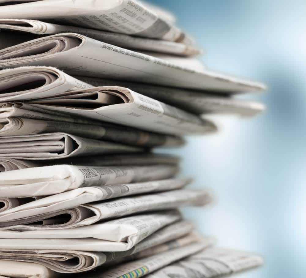 pile of newspapers on white background